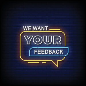 Neon sign saying "We want your feedback"